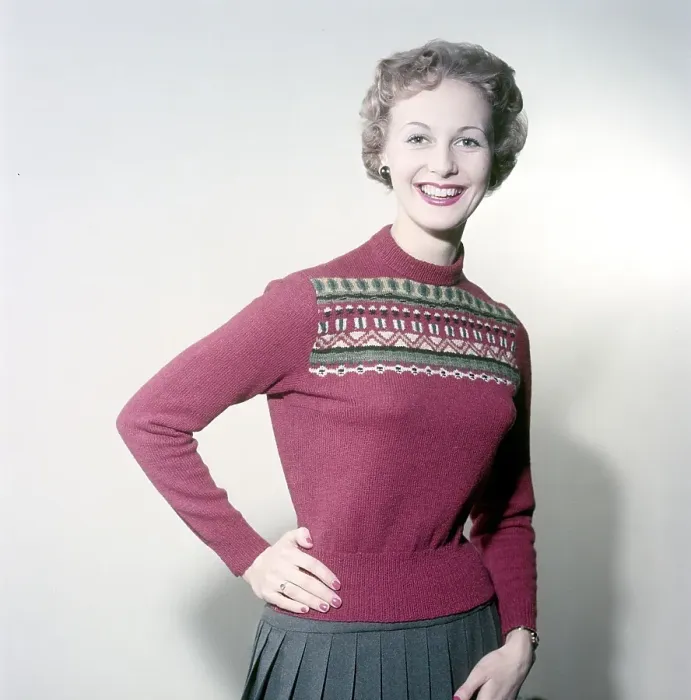 Framed Print : In the 1950s. A woman modelling a 1950s red knitted sweater with pattern