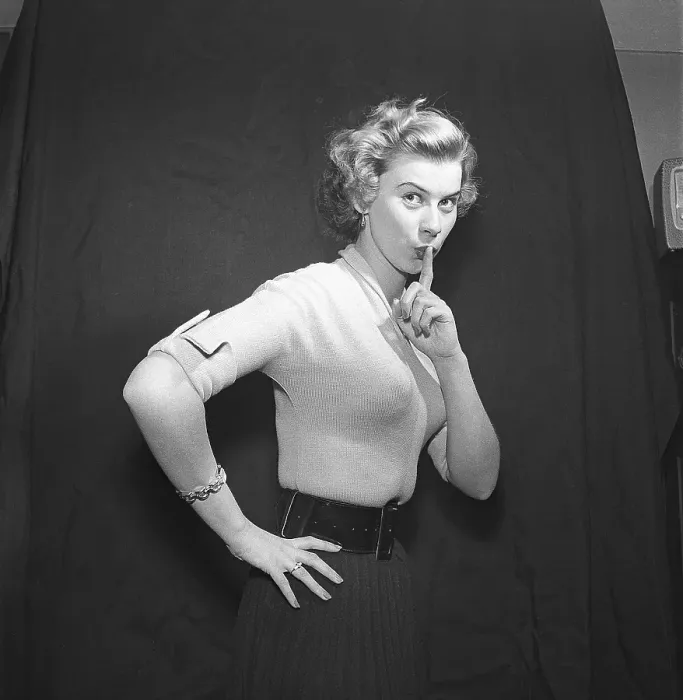 Framed Print : In the 1950s. A young blonde woman is looking into the camera