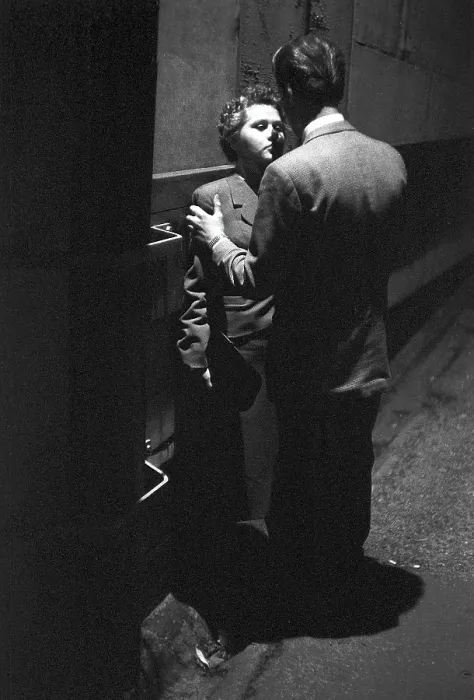 Framed Print : In the 1950s. A young couple in the evening standing close to each other Framed Print : In the 1950s. A young couple in the evening standing close to each other