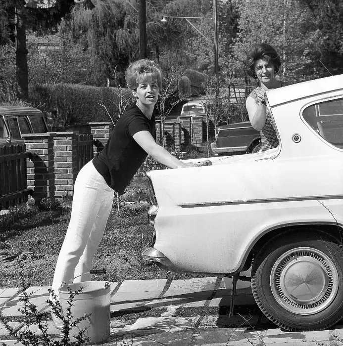Framed Print : In the 1960s. Actress singer Lill-Babs washing her car, a Ford Anglia. her mother to the right. Sweden 1964