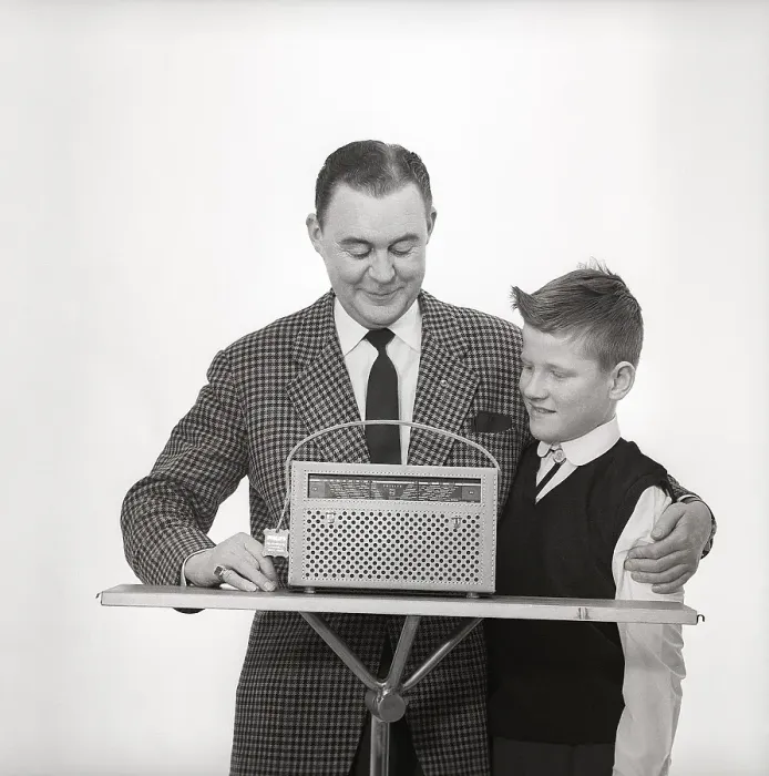 Framed Print : In the 1960s. Father and son with a radio Framed Print : In the 1960s. Father and son with a radio