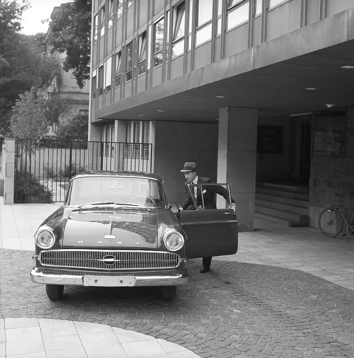 Framed Print : In the 1960s. A man is seen standing at his car Framed Print : In the 1960s. A man is seen standing at his car