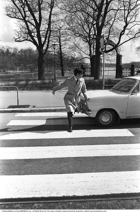 Framed Print : In the 1960s. A moment when a man walks on a pedestrian crossing but a car has not noticed him and keeps driving