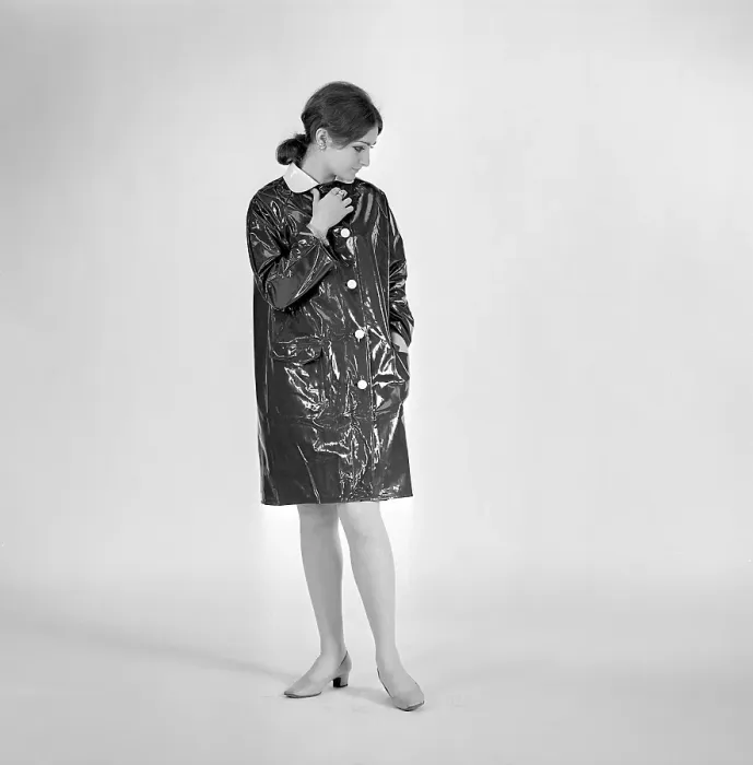 Framed Print : 1960s woman in raincoat. A young woman dressed in a raincoat of plastic material Framed Print : 1960s woman in raincoat. A young woman dressed in a raincoat of plastic material