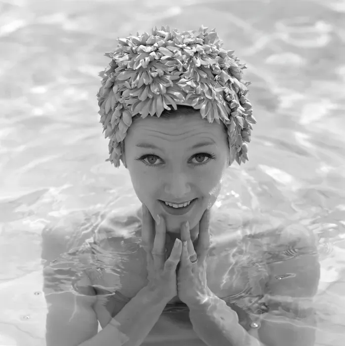 Framed Print : In the 1960s. A young woman pictured in the swimming pool wearing a typical 1960s bathing cap in a plastic material Framed Print : In the 1960s. A young woman pictured in the swimming pool wearing a typical 1960s bathing cap in a plastic material