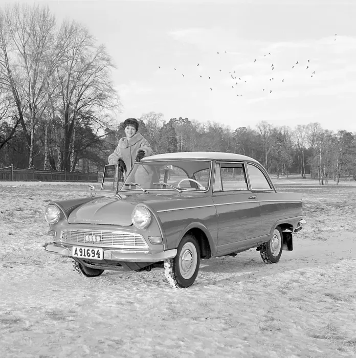 Framed Print : In the 1960s. A young woman in the winter with her brand new car
