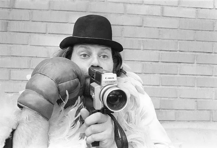 Framed Print : In the 1970s. A man is filming with a amateur film camera Framed Print : In the 1970s. A man is filming with a amateur film camera