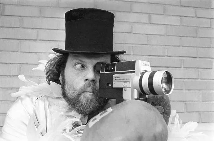 Framed Print : In the 1970s. A man is filming with a amateur film camera