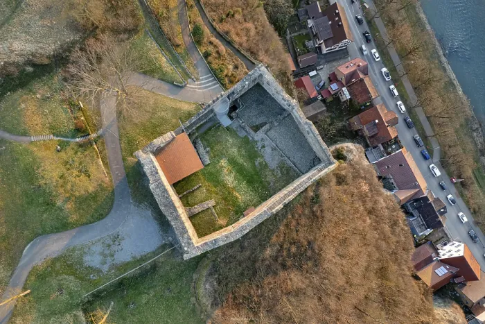 Framed Print : Aerial view of a castle ruins with adjacent streets and houses