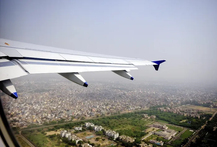 Framed Print : Aerial view of city and aircraft wing