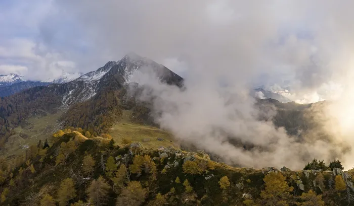 Framed Print : Aerial view of Corno di Gesero with clouds and autumn forest in the foreground