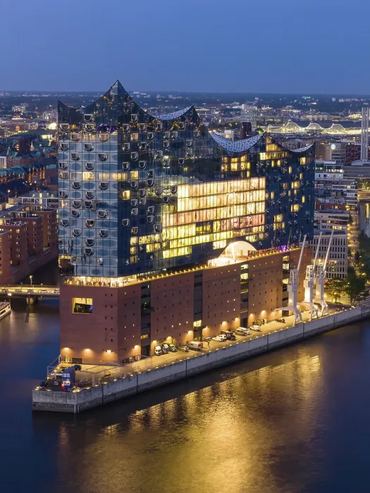 Framed Print : Aerial view of the Elbphilharmonie at blue hour with illuminated windows and view over the Speicherstadt and Hafencity