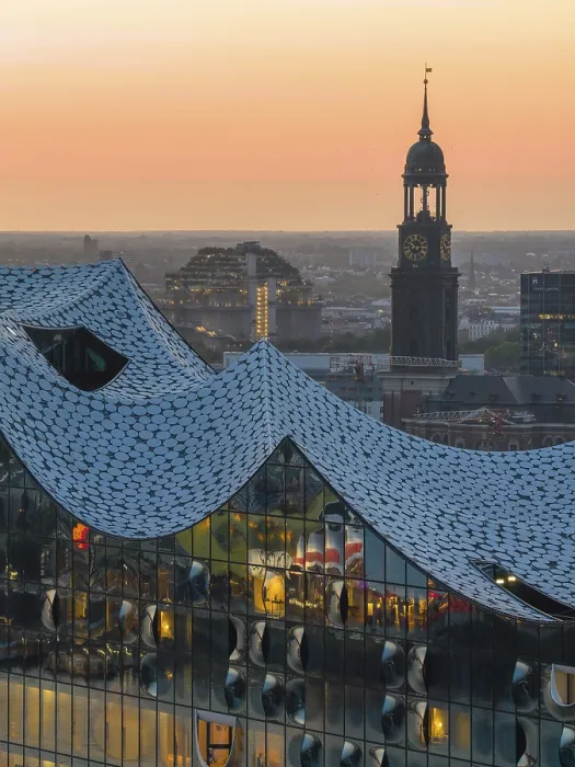 Framed Print : Aerial view of the Elbphilharmonie at sunset with illuminated windows and view over Hamburg