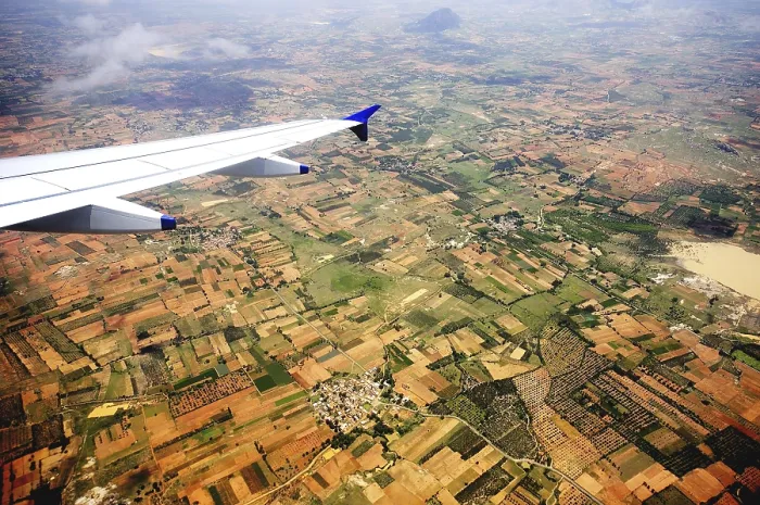 Framed Print : Aerial view of field and aircraft wing