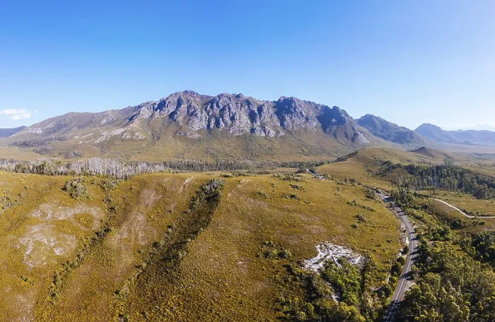 Framed Print : An aerial view of Gordon River Rd at the Sentinel range of mountains near Bitumen Bones Sculpture on a hot