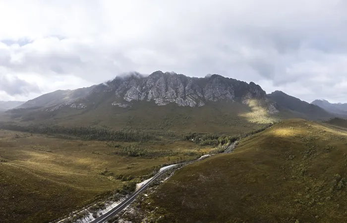 Framed Print : An aerial view of Gordon River Rd at the Sentinel range of mountains near Bitumen Bones Sculpture on a hot