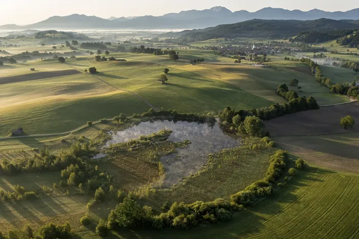 Framed Print : Aerial view of a lake in front of mountains in summer