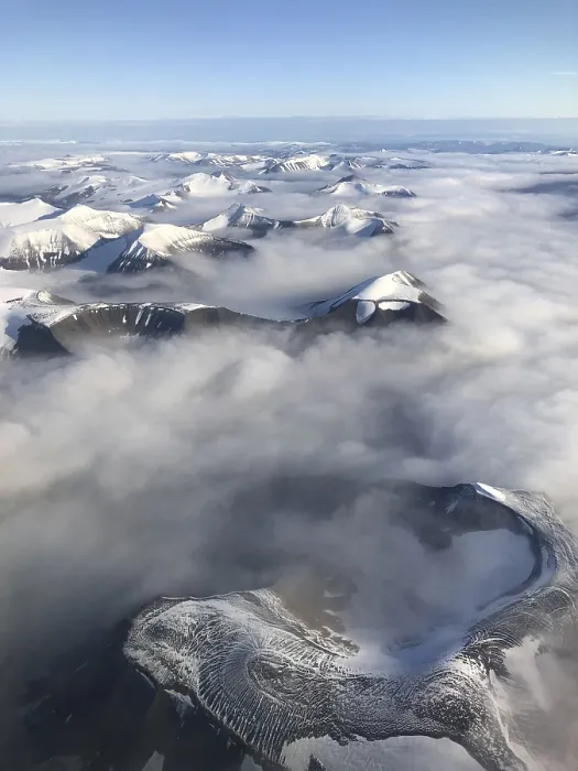 Framed Print : Aerial view, mountain peak with snow above cloud cover Framed Print : Aerial view, mountain peak with snow above cloud cover