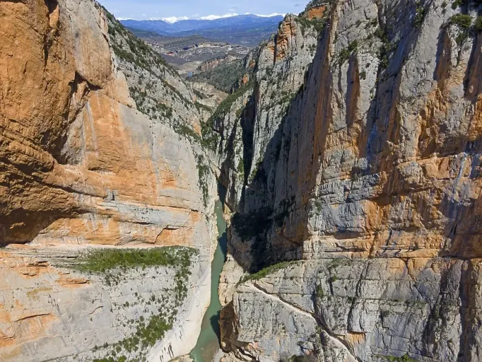 Framed Print : An aerial view of a narrow gorge with steep rock faces and a river flowing through the valley Framed Print : An aerial view of a narrow gorge with steep rock faces and a river flowing through the valley