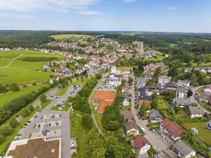 Framed Print : Aerial view of a picturesque village with green areas and the sky in the background