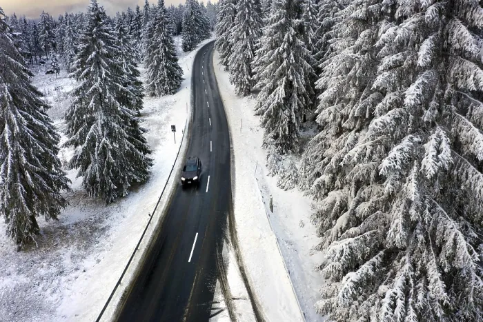 Framed Print : Aerial view, road leads through a snow-covered forest area near Sankt Andreasberg