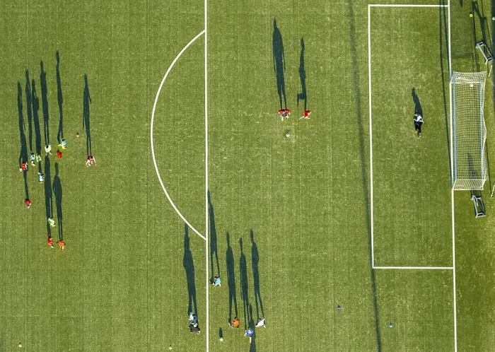 Framed Print : Aerial view, soccer practice, players casting long shadows Framed Print : Aerial view, soccer practice, players casting long shadows