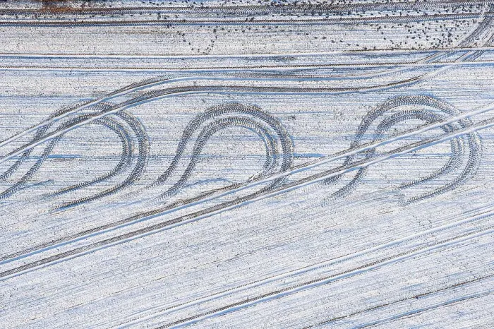Framed Print : Aerial view tractor tracks on a snowy field Framed Print : Aerial view tractor tracks on a snowy field