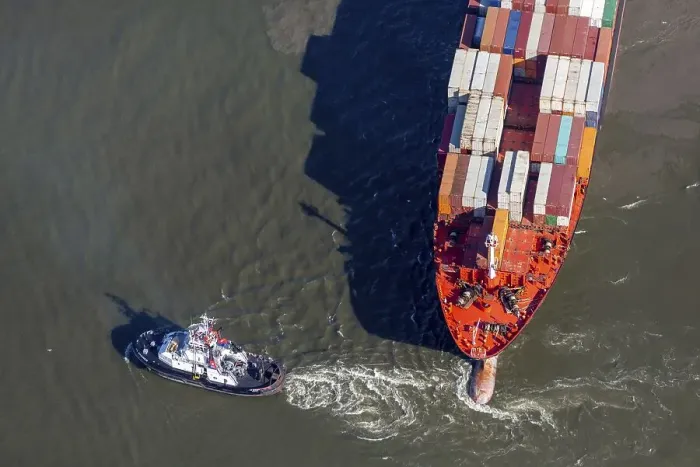 Framed Print : Aerial view of a tugboat pulling a container ship on the Elbe and giving direction