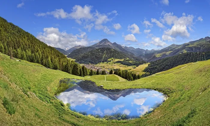 Framed Print : Alpine meadow with small lake and reflection