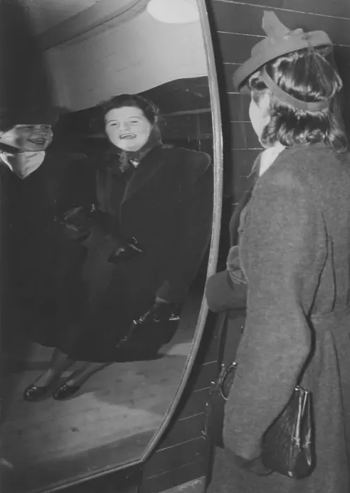 Framed Print : Amusement park in the 1940s. Two women are laughing at how they look in a funny mirror