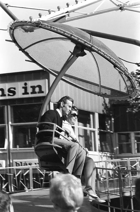 Framed Print : Amusement park in the 1960s. A couple is seen in one of the attractions that are offered on the grounds