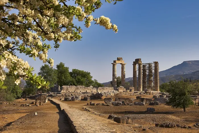 Framed Print : Ancient temple columns with blooming trees and mountains in the background under clear sky Framed Print : Ancient temple columns with blooming trees and mountains in the background under clear sky