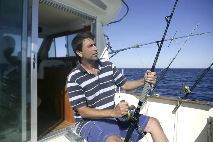 Framed Print : Angler big game saltwater fisher boat with rods and reels