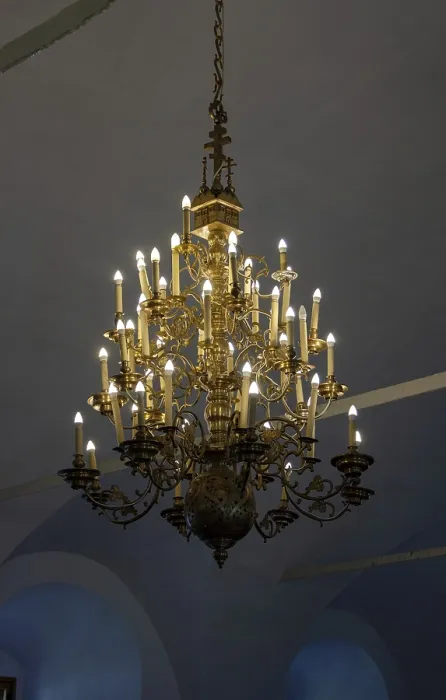Framed Print : Antique chandelier with electric candles under the arches of a Christian monastery