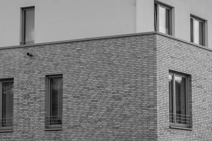 Framed Print : Architectural detail of a modern brick building showing windows and a drainpipe