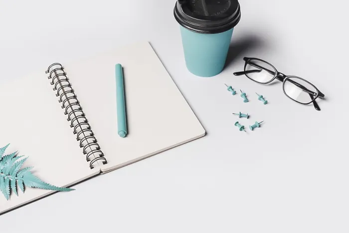 Framed Print : Artificial fern leaves pen white blank spiral notebook with coffee cup eyeglasses push pin Framed Print : Artificial fern leaves pen white blank spiral notebook with coffee cup eyeglasses push pin