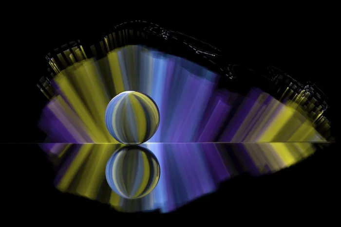 Framed Print : Artistic picture with coloured illuminated sphere and light effects in front of a black background