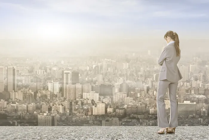 Framed Print : Asian businesswoman standing on the roof and looking at city