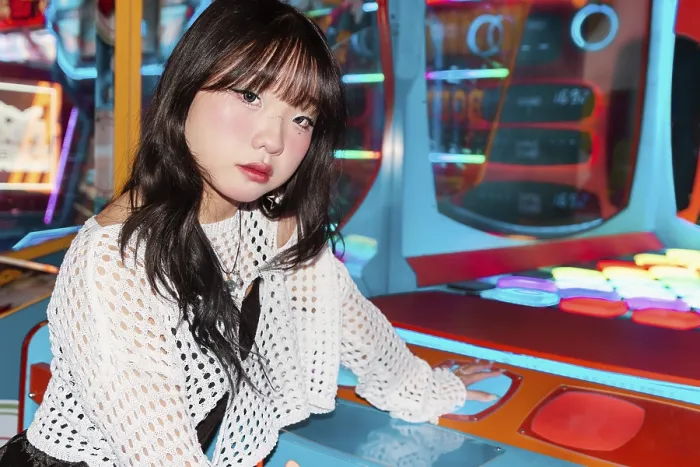 Framed Print : An Asian Gen Z girl enjoys an arcade game