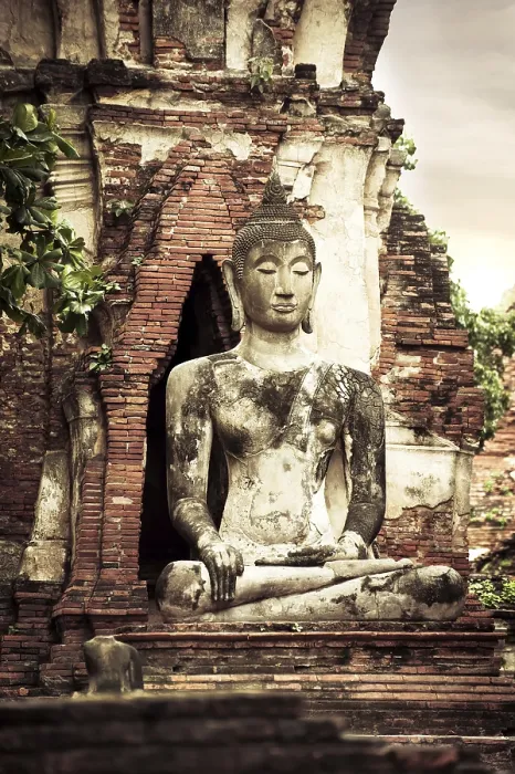 Framed Print : Asian religious architecture. Ancient sandstone sculpture of Buddha at Wat Mahathat ruins under sunset sky