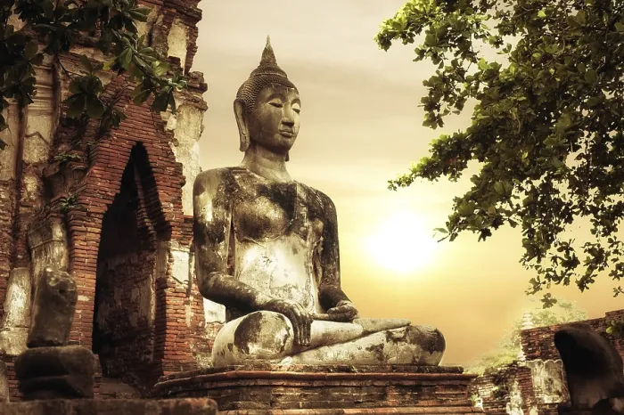 Framed Print : Asian religious architecture. Ancient sandstone sculpture of Buddha at Wat Mahathat ruins under sunset sky