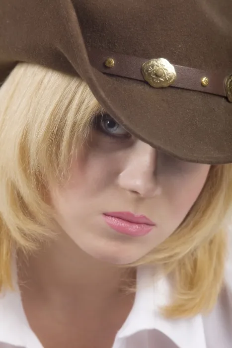 Framed Print : Attractive cowgirl in brown hat close up