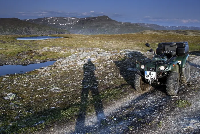 Framed Print : ATV is standing on a dirt road next to a long shadow of people in the vast countryside Framed Print : ATV is standing on a dirt road next to a long shadow of people in the vast countryside