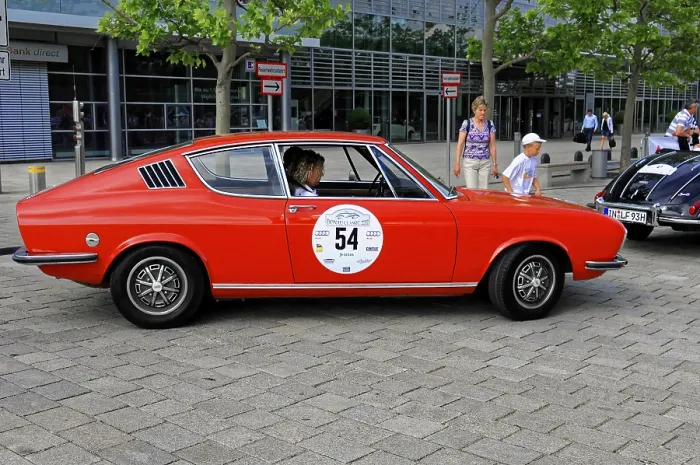 Framed Print : AUDI 100 Coupe S, red classic car in a city environment surrounded by people and modern architecture