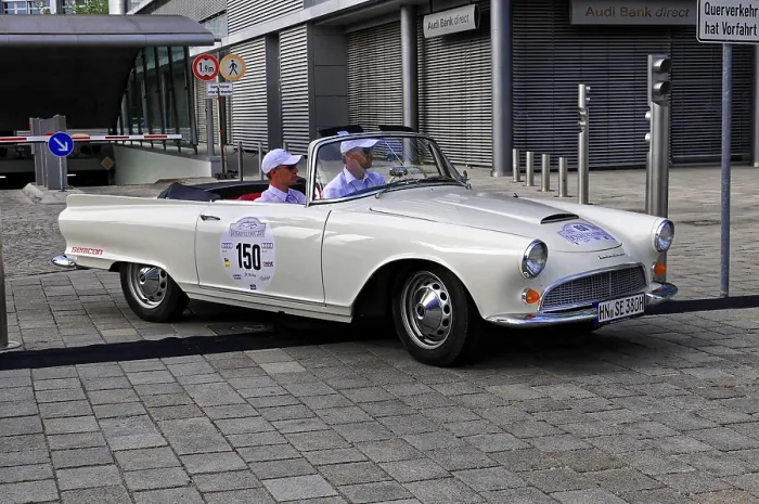 Framed Print : Auto Union 1000 SP, white vintage convertible in the foreground with modern architecture