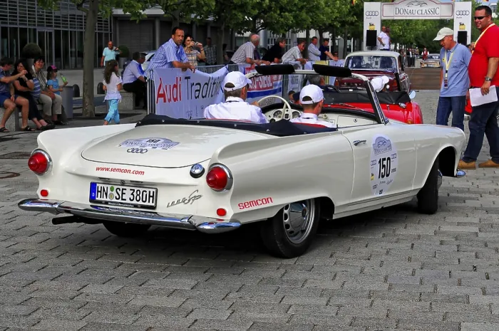 Framed Print : Auto Union 1000 SP, white vintage roadster with people in the background during an event Framed Print : Auto Union 1000 SP, white vintage roadster with people in the background during an event