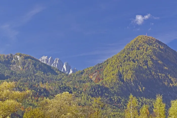 Framed Print : Autumn alpine slopes with round and jagged peaks under clear