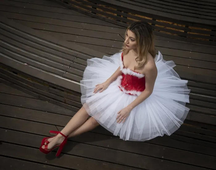 Framed Print : Ballerina wearing christmas white red dress posing on the floor Framed Print : Ballerina wearing christmas white red dress posing on the floor