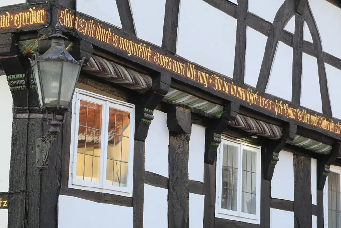 Framed Print : Banner on the facade of a 16th century half-timbered house