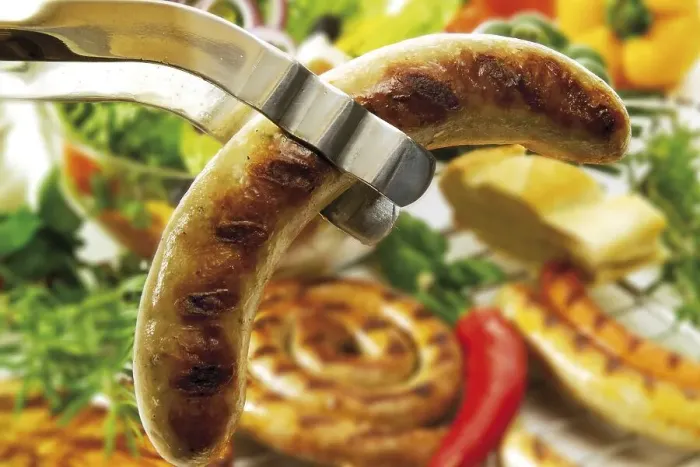 Framed Print : Barbecue tongs with fried sausage